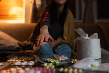 Flu and disease. Woman reaches hand for pills. Palm and medicine close-up. Concept of depression treatment and psychology problem
