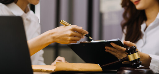 Male lawyer working with contract papers and wooden gavel on tabel in courtroom. justice and law ,attorney, court judge, concept.