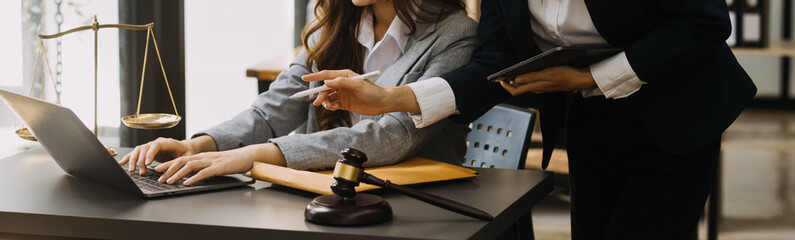 Male lawyer working with contract papers and wooden gavel on tabel in courtroom. justice and law ,attorney, court judge, concept.