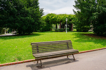 An empty bench in a middle of a green park, Spain