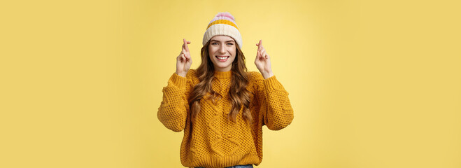 Optimistic lucky cute young stylish female university student praying god help pass exams cross...