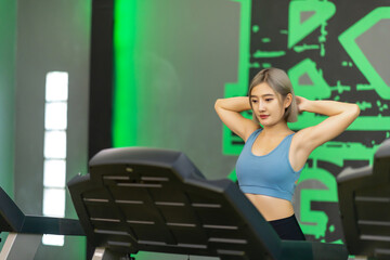 Cute young Young woman exercising on a treadmill at a gym