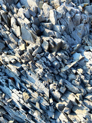 Coarse natural rock Stone background. Mining cliff rough front surface.