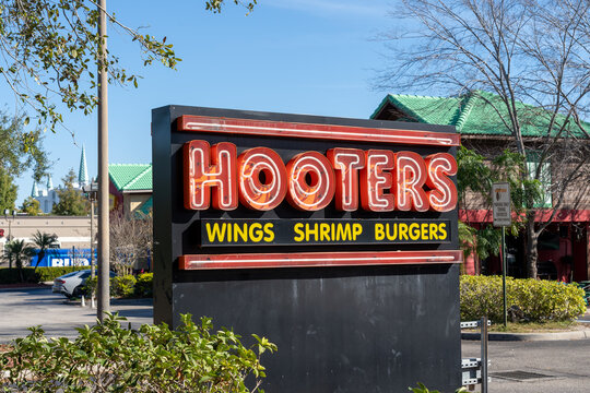 Orlando, FL, USA - January 6, 2022: A Hooters restaurant sign is shown in Orlando, FL, USA. Hooters is the registered trademark used by two American restaurant chains. 