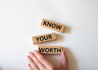 Know your worth symbol. Wooden blocks with words Know your worth. Beautiful white background. Businessman hand. Business and Know your worth concept. Copy space.