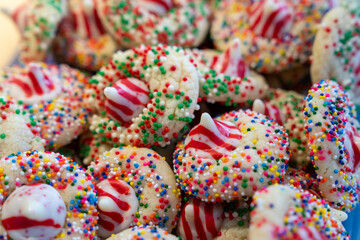 Fototapeta na wymiar Colorful Christmas cookies made with peppermint kisses and rainbow sprinkles, selective focus