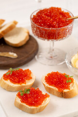 Sandwiches with red caviar on a baguette