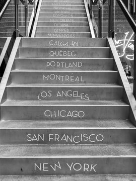 Canadian and American city names written on steps, Gastown; Vancouver, British Columbia, Canada