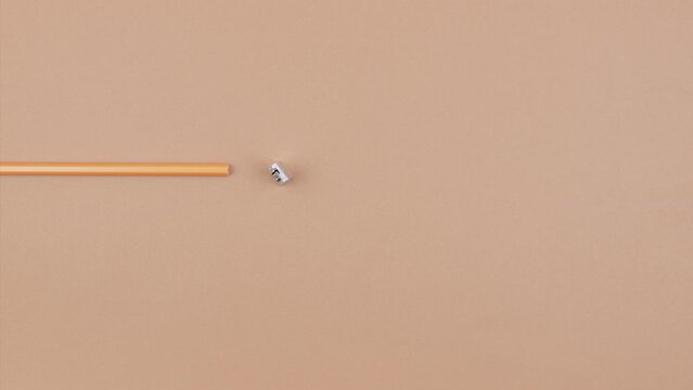 Stop motion animation of sharpener sharpening one of the pencil