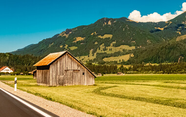 Obraz premium Beautiful alpine summer view with a wooden hut near Langenwang, Oberstdorf, Bavaria, Germany