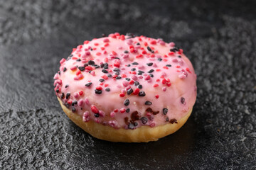 Sweet pink Donut with chocolate, raspberry and strawberry chippings