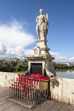 Statue of Archangel San Rafael, circa 1651, on the Puente Romano, Roman Bridge over the the Guadalquivir river; Cordoba, Andalucia, Spain