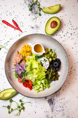 water salad with tuna, olives and other ingredients on a plate