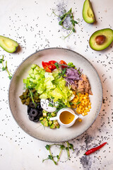 water salad with tuna, olives and other ingredients on a plate