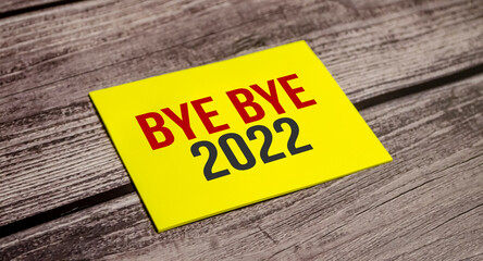 BYE BYE 2022 Text on business paper on office table