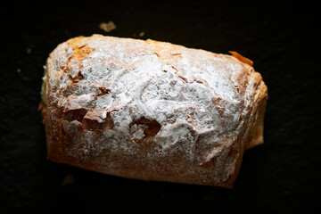 Cream puff bread on a black background	