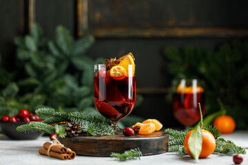 Fototapeta na wymiar Christmas mulled wine on Christmas background. Hot Christmas beverage with orange and cranberry. 