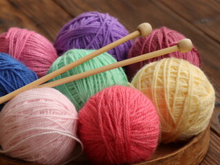 Closeup colorful balls of wool and knitting as hobby collection