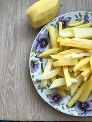raw potatoes cut for making French fries