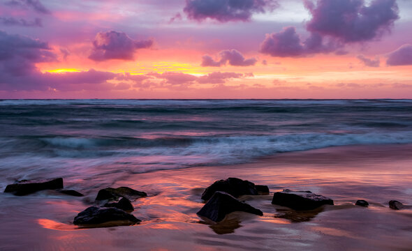 Sunrise over the Pacific ocean, viewed from Lydgate beach; Kapaa, Kauai, Hawaii, United States of America