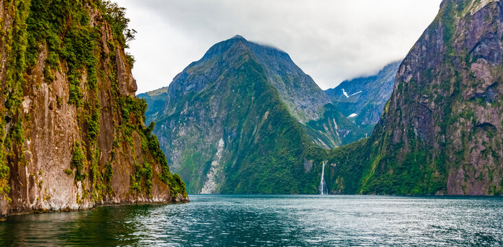 High mountains and rock cliffs, Milford Sound; New Zealand - Powered by Adobe