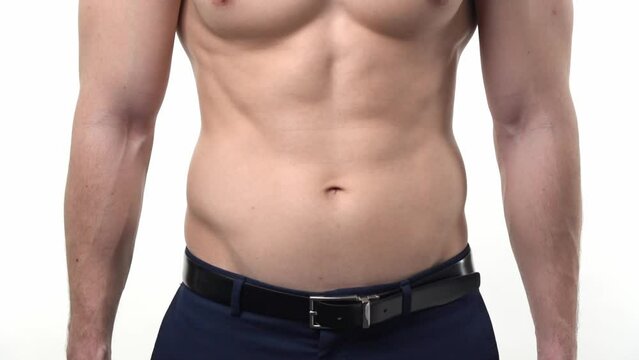 Male athletic muscular torso in office trousers on a white background. The concept of a modern healthy man.