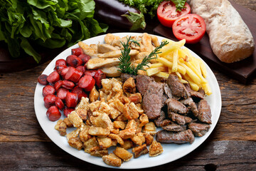 Plate of snacks, meat, potatoes, sausage, cracklings