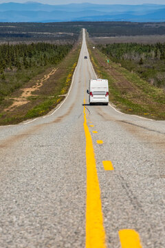 A tour bus travels along a long, lonely stretch of highway between Delta Junction and Paxson, Alaska. Milepost 248, Old Richarson Highway; Alaska, United States of America
