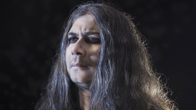 Pessimistic person.
The pessimistic man looks. Black background.
