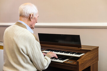 97 year old man playing the electric organ; Hartlepool, County Durham, England