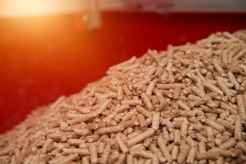 Pellet stove filled with oak pellets. Alternative fuel concept. Heating household with renewable eco energy.