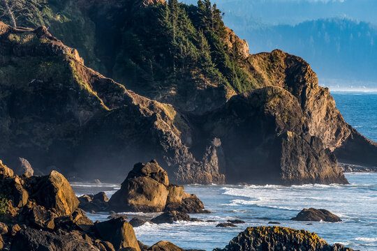 Steep cliffs and dense forest characterize the Oregon Coast at Ecola State Park; Cannon Beach, Oregon, United States of America