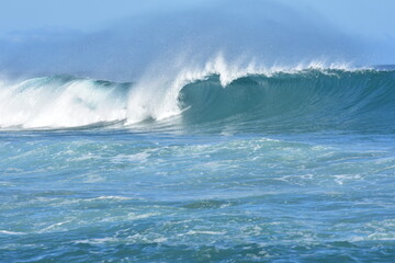 The blue of the  sea and the waves meet the horizon