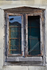 Old wooden window on the abandoned house.