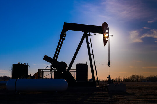 Pumpjack at sunset; Alberta, Canada
