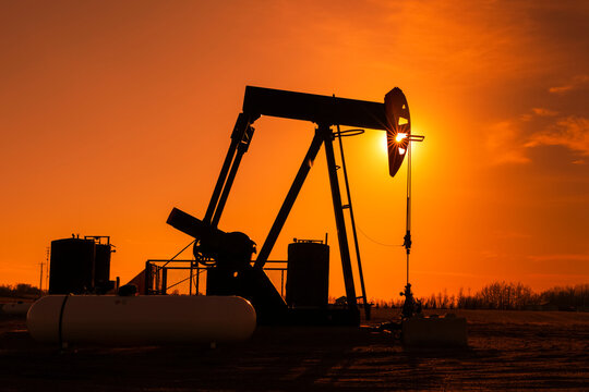 Pumpjack at sunset; Alberta, Canada