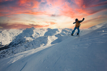 Fototapeta na wymiar Snowboard rider jumping on a beautiful sunny day in the mountains