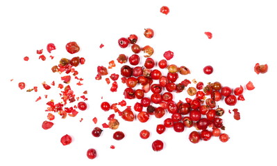 Red peppercorns, crushed pepper pile on white, top view