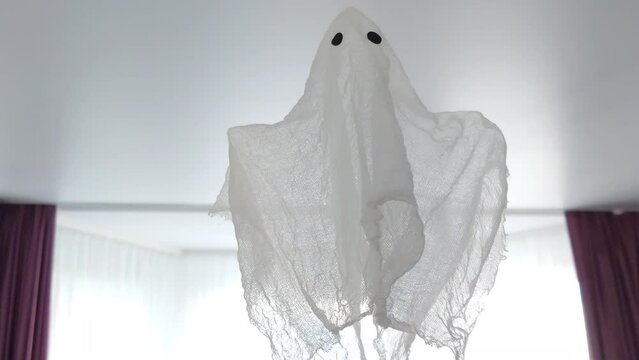 A rag ghost flying in a room near the ceiling