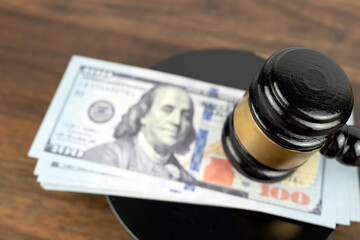 Piles of US 100 dollars bills with Gavel