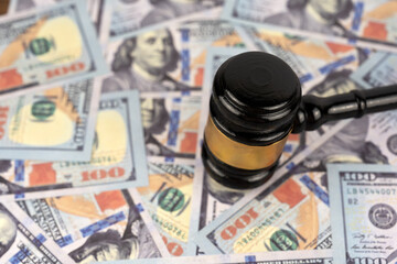 Piles of US 100 dollars bills with Gavel