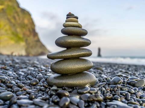 Close-up of a stack of stones balancing on the rocky beach along the coast of Southern Iceland; Myrdalshreppur, Southern Region, Iceland