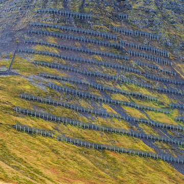 Snow barriers on a mountainside to control avalanches during the winter season; Isafjardarbaer, Westfjords, Iceland
