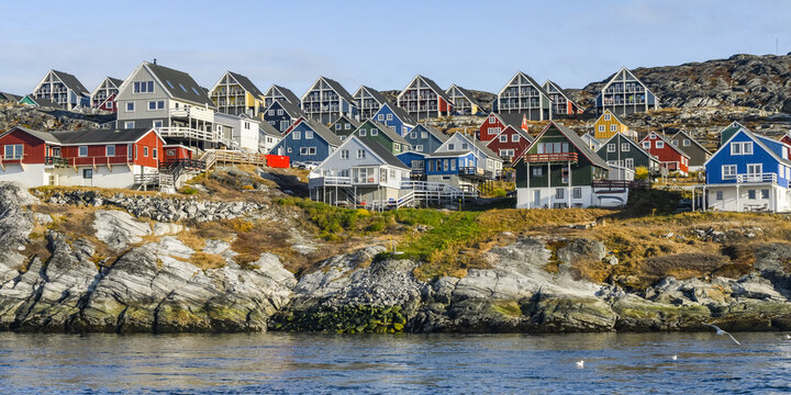 Colourful houses along the rocky shore of Nuuk; Nuuk, Sermersooq, Greenland