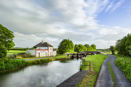 Old red and white house beside a lock on the grand canal in Kildare on a summer evening; Rathangan, County Kildare, Ireland