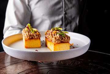 chef holding brioche with foie gras in hand