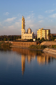 Mosque on the Nile reflected in the water; Aswan, Egypt