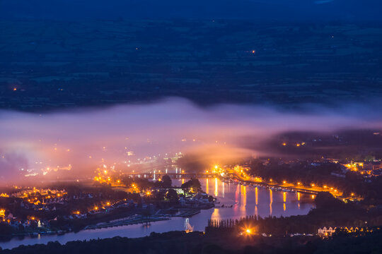 The twin towns of Ballina and Killaloe at night on the River Shannon with fog hanging over the towns; Killaloe, County Clare, Ireland