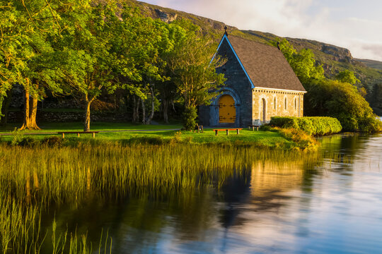 Close-up of the Gougane Barra chapel surrounded by trees and reeds at sunrise; Gougane Barra, County Cork, Ireland