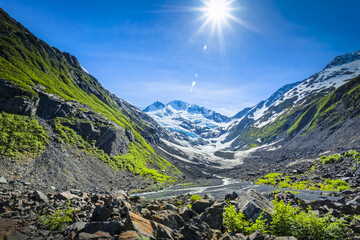 Sun blazes over Byron Glacier and Byron Peak. Portage Valley, Chugach National Forest, South-central Alaska in springtime; Alaska, United States of America